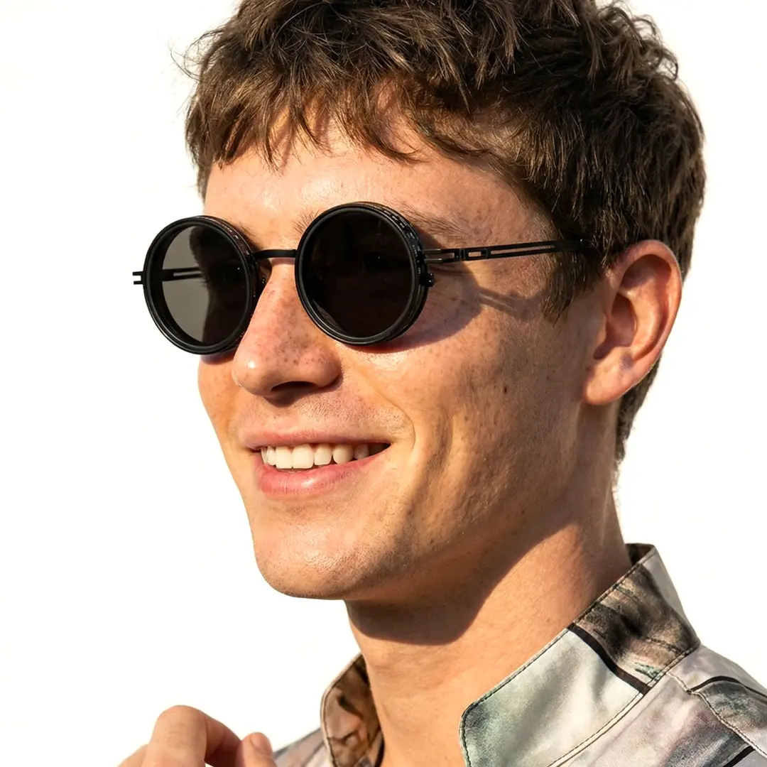 Profile view of male wearing steampunk black round sunglasses, smiling, RM0352507