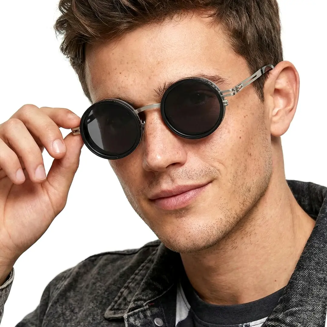 Profile view of male wearing steampunk silver round sunglasses, adjusting glasses, natural smile, RM0352507