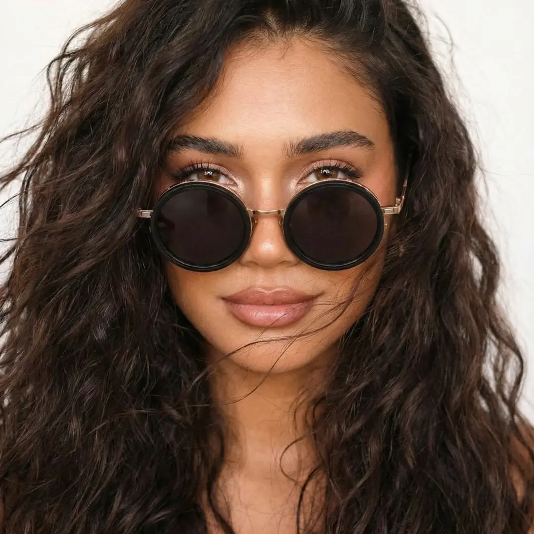 Straight-on view of female wearing steampunk gold round magnetic clip-on sunglasses set with interchangeable clip-on lenses, calm expression, RM0382507