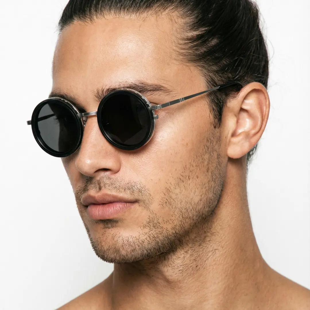 Profile view of male wearing steampunk silver round magnetic clip-on sunglasses set with interchangeable clip-on lenses, neutral expression, RM0382507