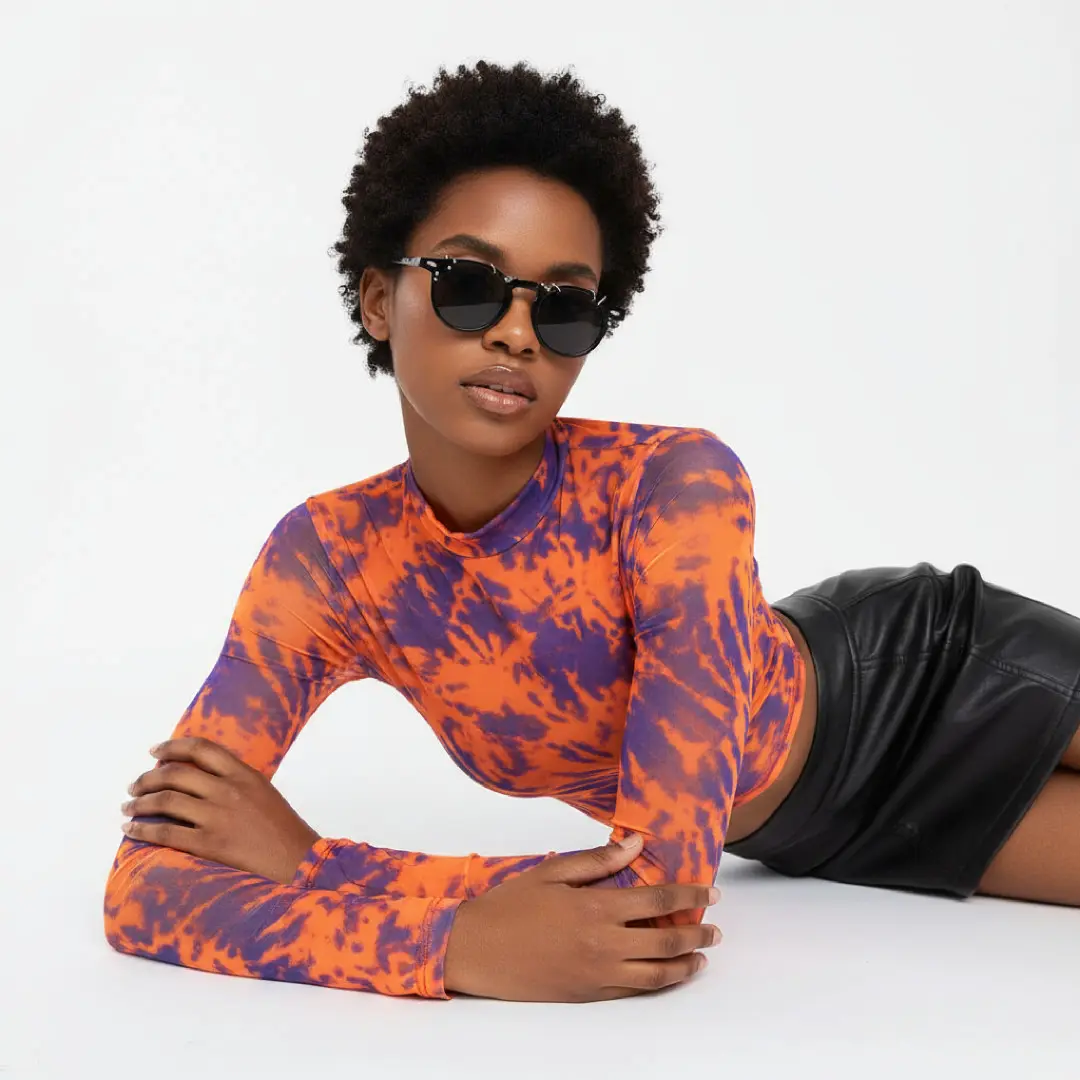 Three-quarter view of female wearing black round handcrafted polarized sunglasses, relaxed expression, RP0042511