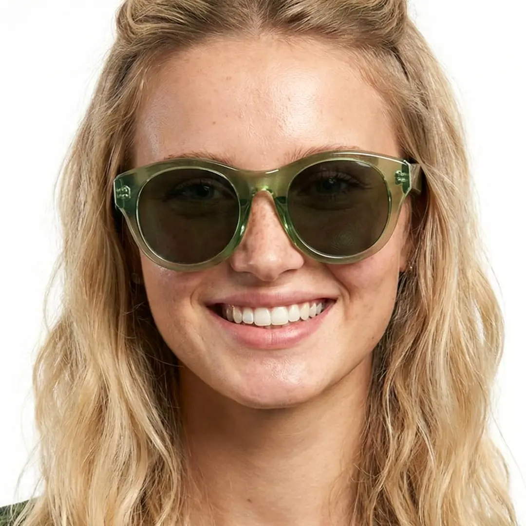Front view of female wearing green round sunglasses, smiling, RR0242302