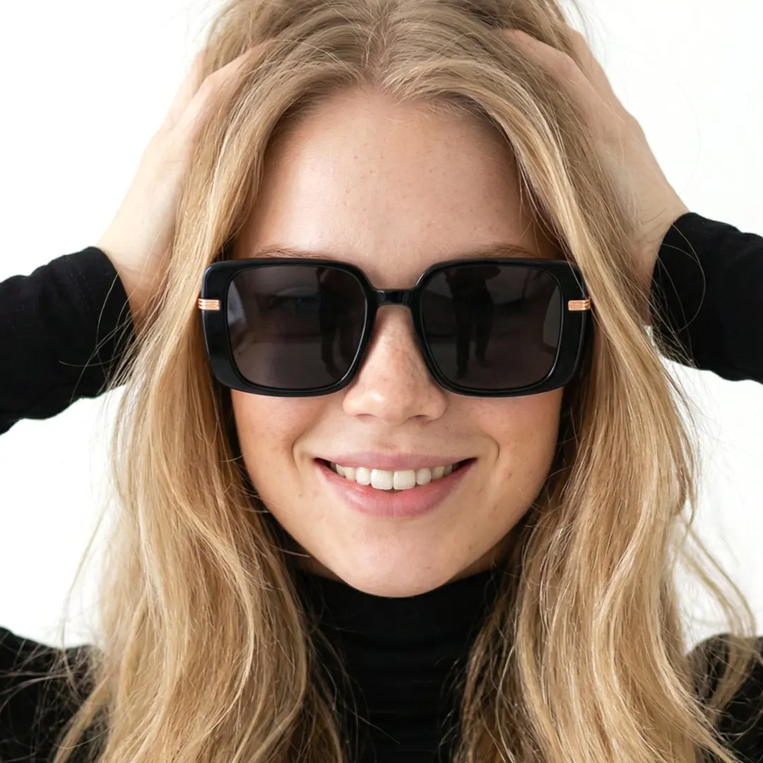 Front view of female wearing fashion black square sunglasses, hand in hair, natural smile, SA0392503S