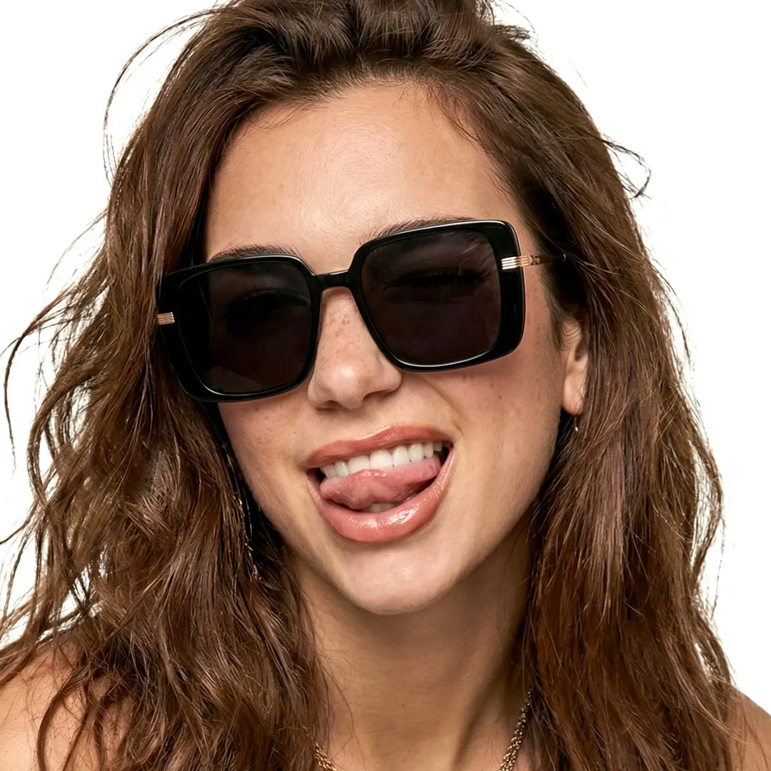 Front view of female wearing brown square sunglasses, sticking out tongue, smiling, SA0392503S