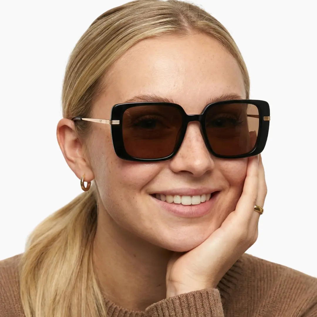 Slightly angled view of female wearing brown square sunglasses, natural smile, SA0392503S
