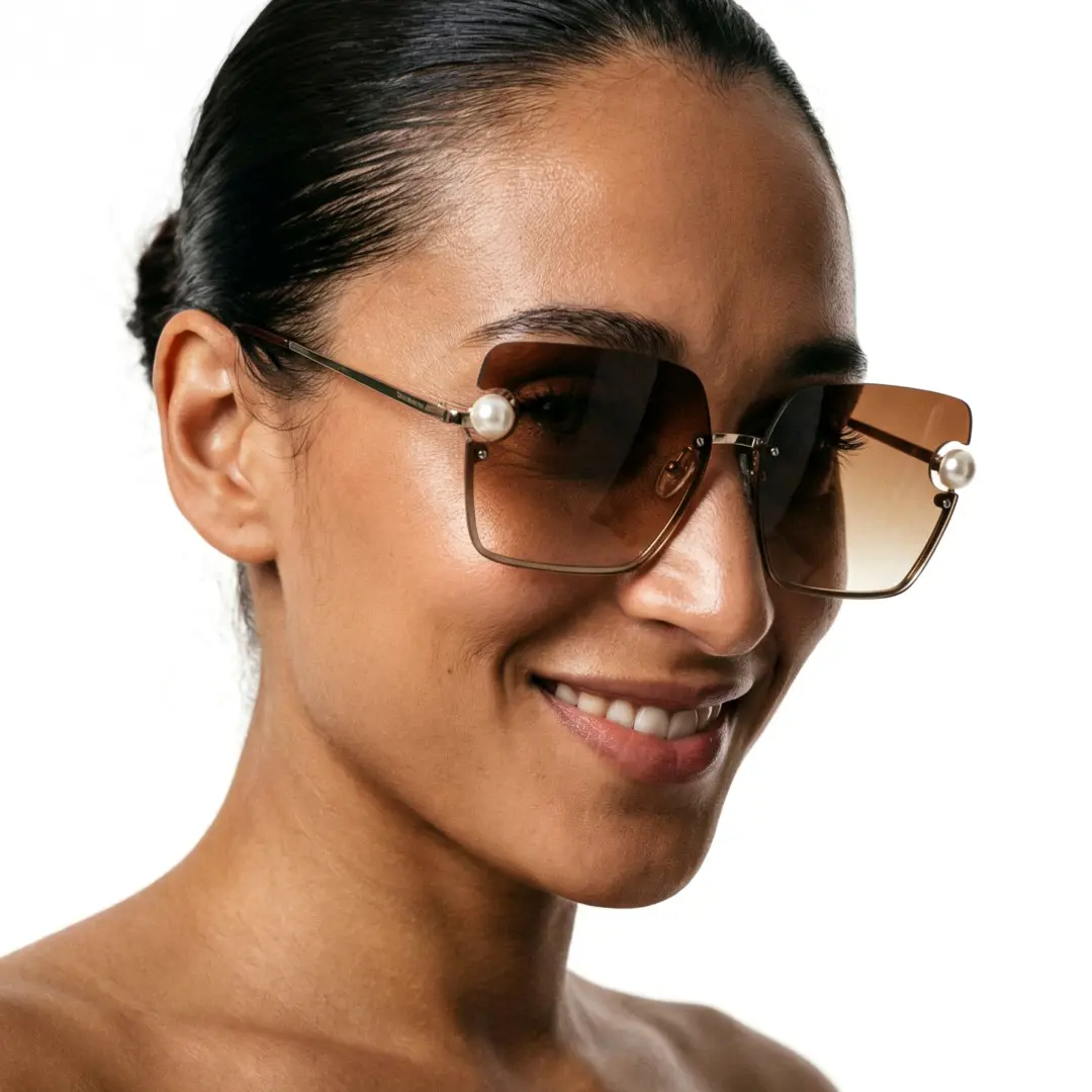 Profile view of female wearing beige square sunglasses, smiling, SP0052505