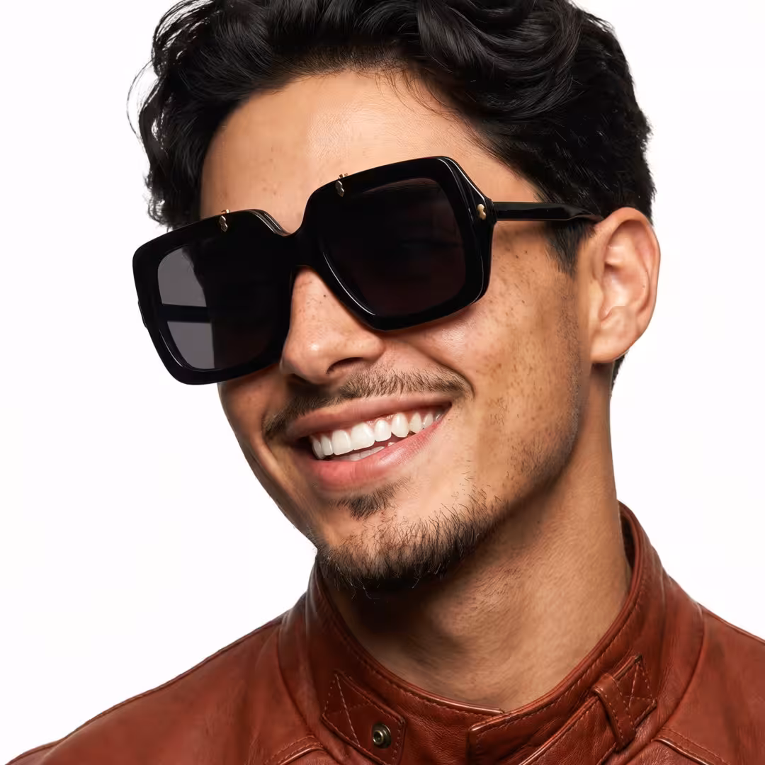 Three-quarter view of male wearing vintage black square flip-up eyeglasses, smiling, SP0192603