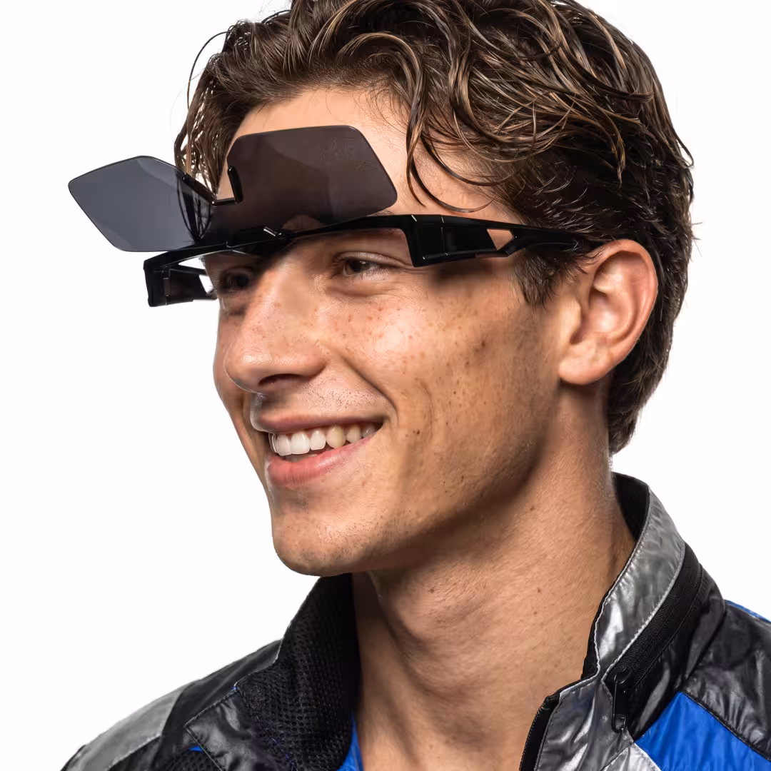 Profile view of male wearing black square flip-up sunglasses, smiling, SR0062605