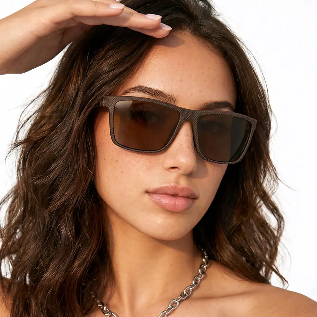 Face close-up view of female wearing brown square sunglasses, hand in hair, relaxed expression, SR0072410