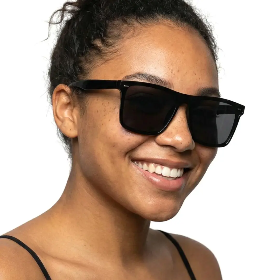 Slightly angled view of female wearing black square sunglasses, smiling, SR0112506