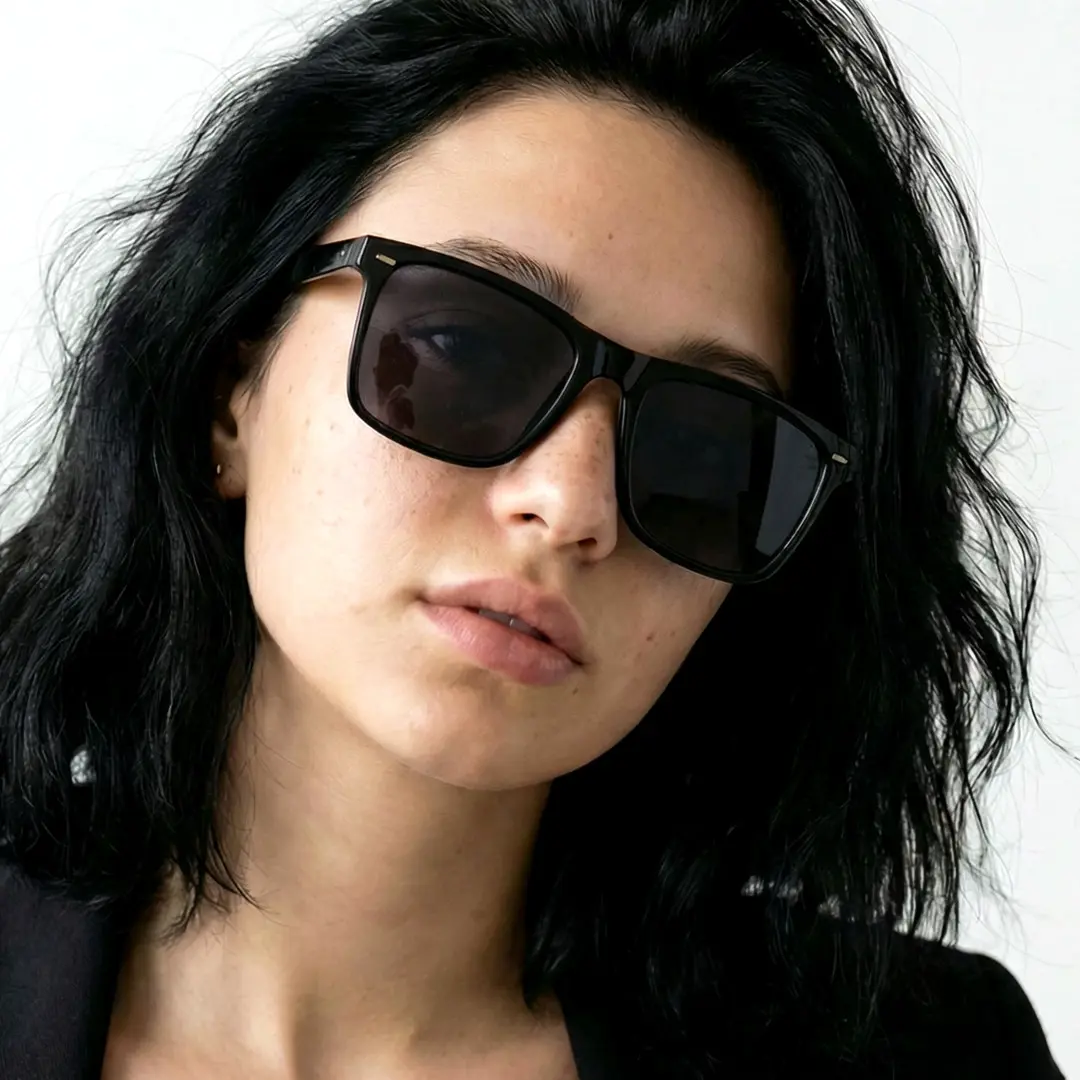 Tilted head view of female wearing black square sunglasses, calm expression, SR0112506