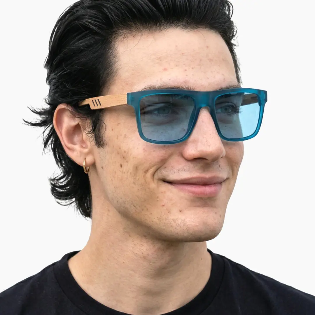 Three-quarter view of male wearing blue square sunglasses, friendly smile, SX0012304
