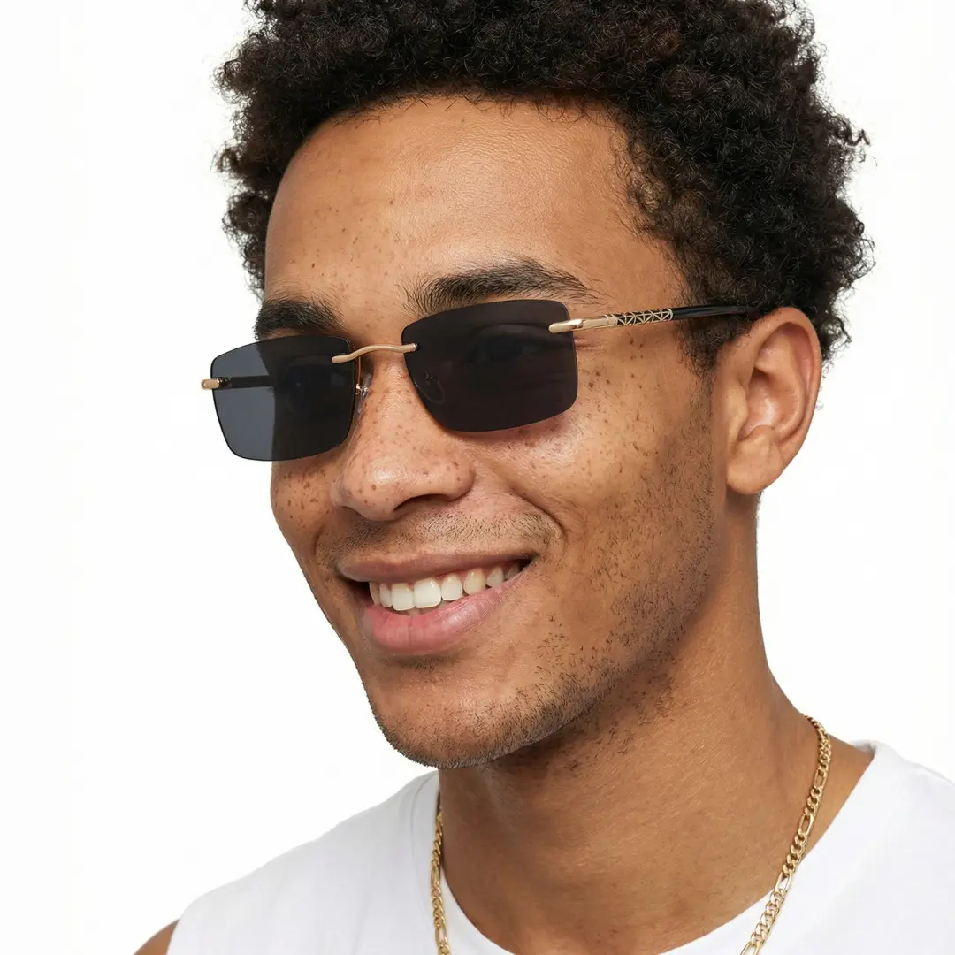 Three-quarter view of male wearing gold square sunglasses, smiling, SX0152507S