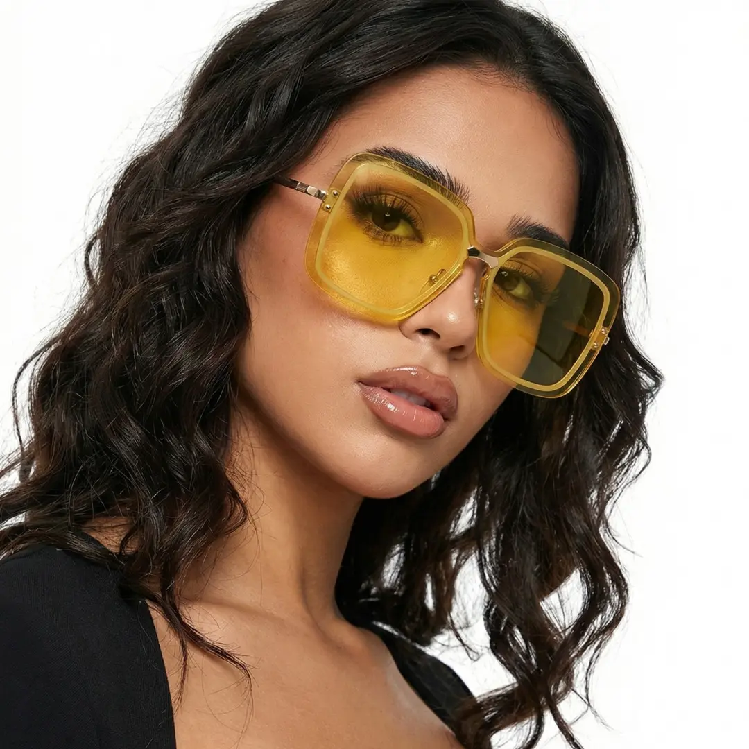 Front view of female wearing yellow square sunglasses, tilting head, natural expression, SX0372508