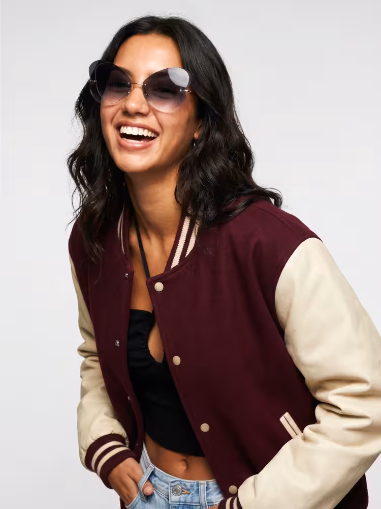 Female model wearing retro chic rimless black unique metal sunglasses in studio setting. SPU: UM0102604
