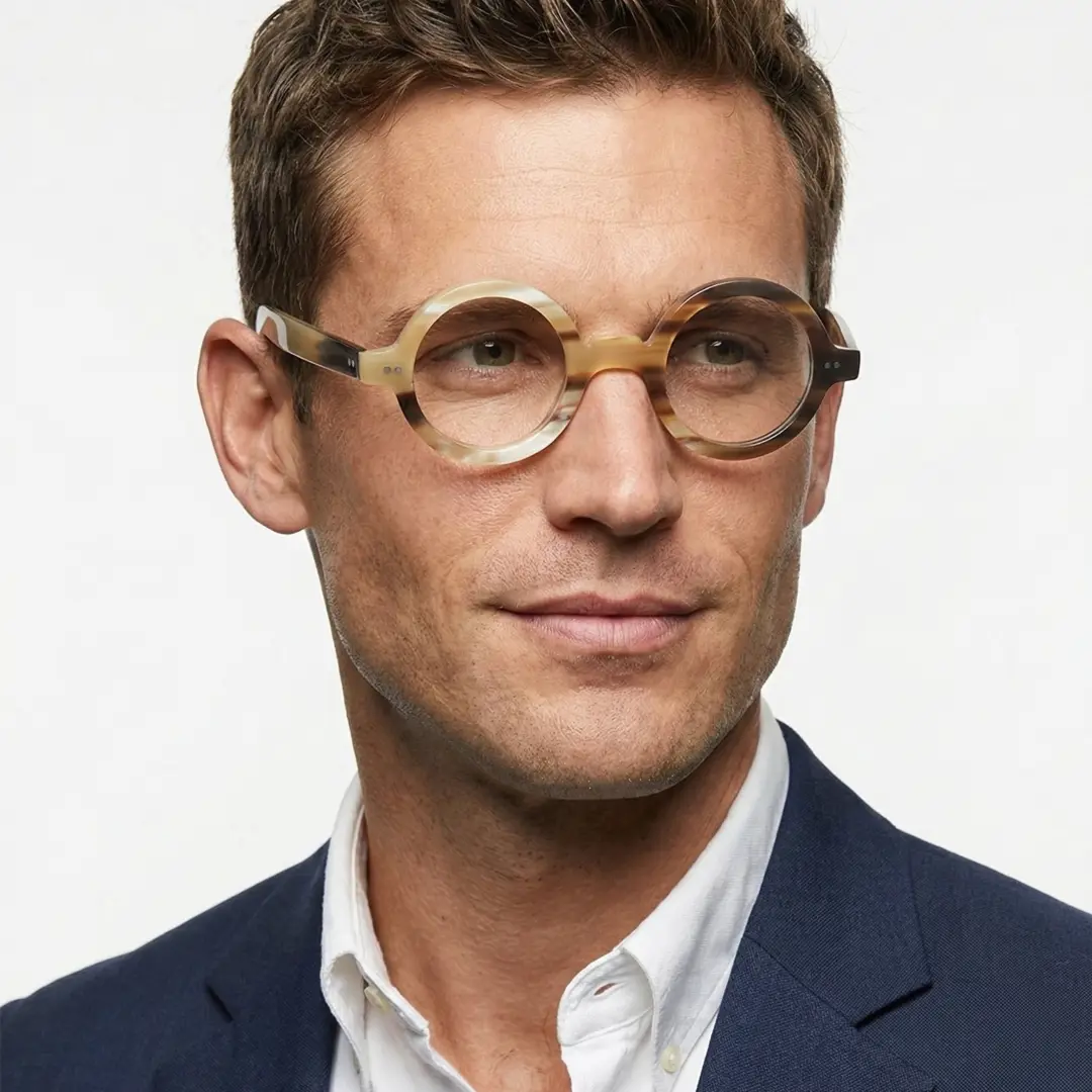 Three-quarter view of male wearing yellow round eyeglasses, friendly smile, RO0262511