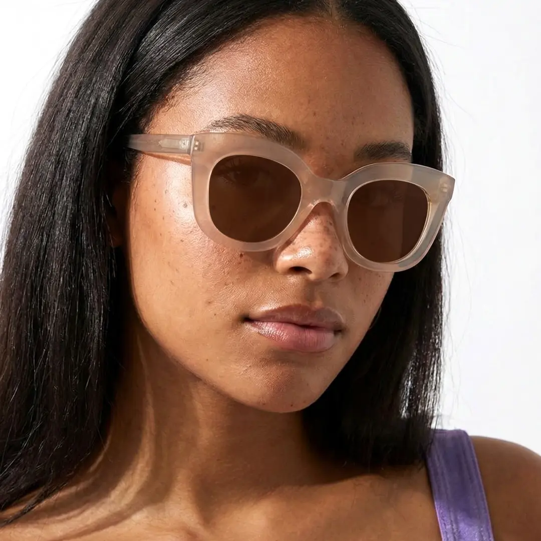 Three-quarter view of female wearing beige cat eye sunglasses, calm expression, CR0172404
