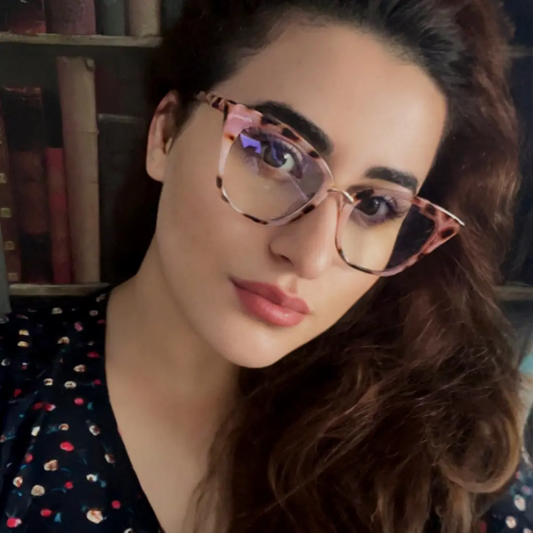 Looking straight ahead view of female wearing red tortoise cat eye eyeglasses, neutral expression, CR0012211