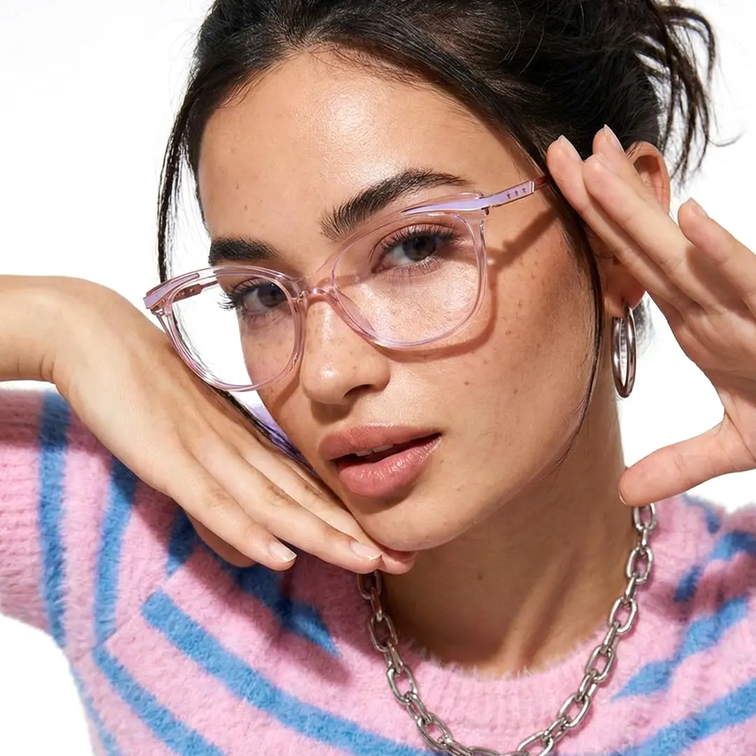 Three-quarter view of female wearing pink cat eye eyeglasses, relaxed expression, CR0072408