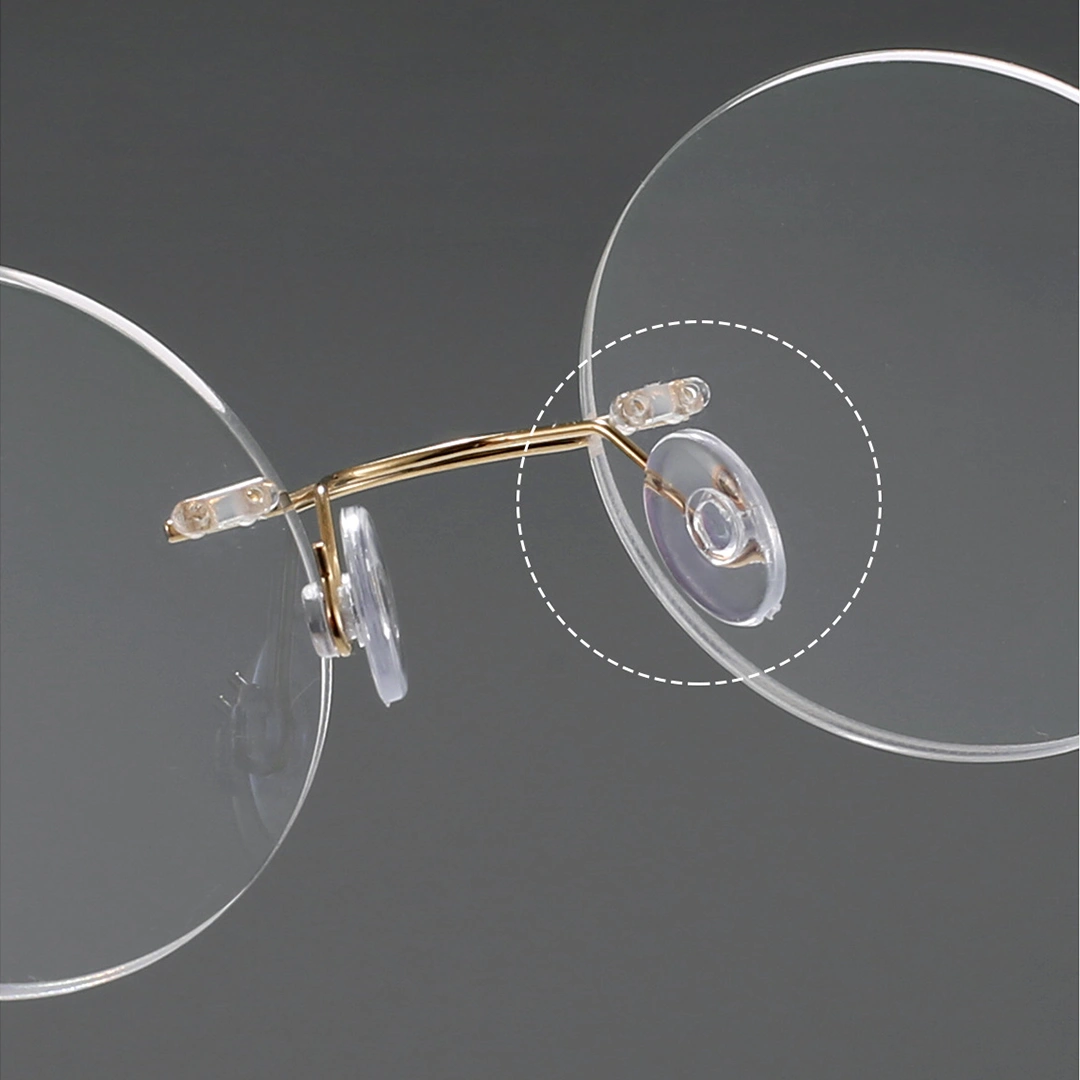 Adjustable nose pad detail of Darcy round titanium eyeglasses RT0012506 in gold
