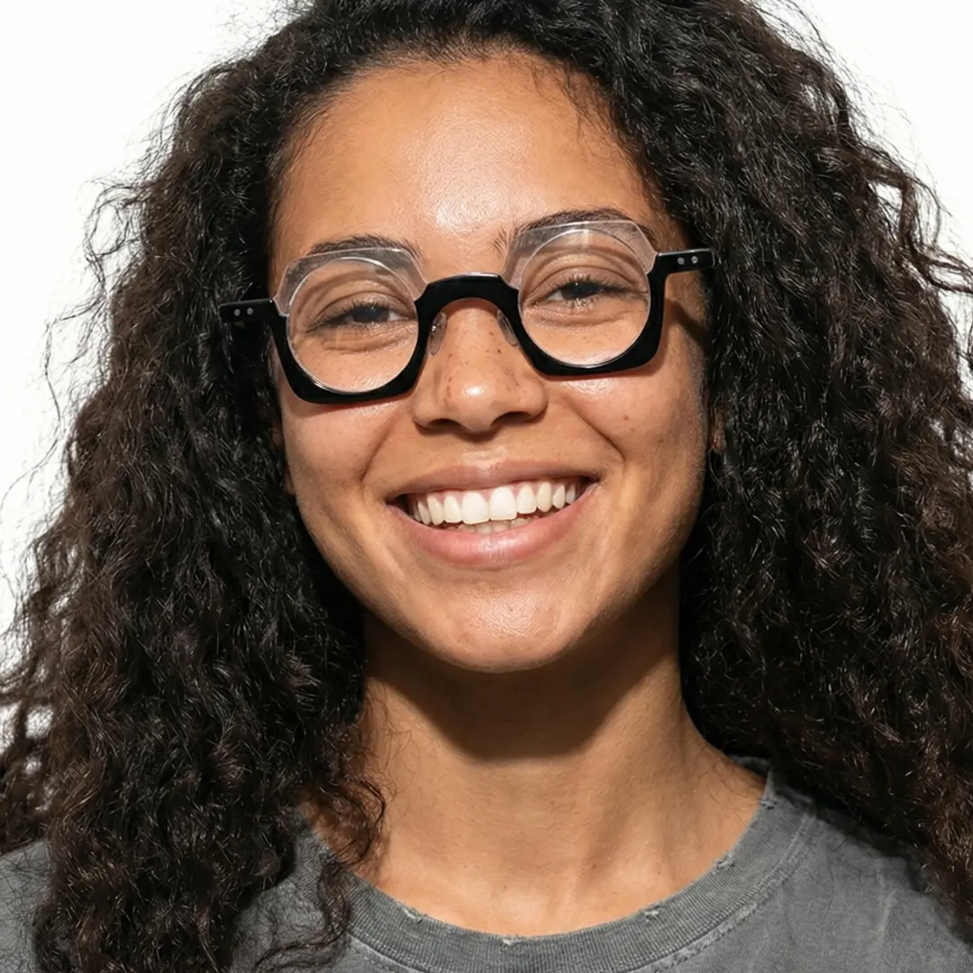 Front view of female wearing black unique eyeglasses, smiling, UA0052302