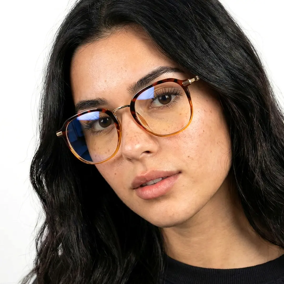 Front view of female wearing tortoise square eyeglasses, tilting head, relaxed expression, SR0012502