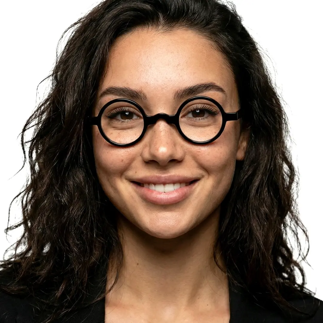 Front view of female wearing vintage black round eyeglasses, smiling, RA0332507